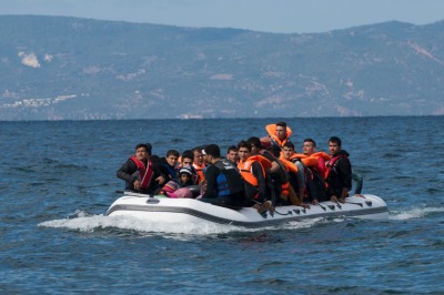 An inflatable boat filled with refugees and other migrants approaches the north coast of the Greek island of Lesbos. Turkey is visible in the background. More than 500,000 migrants have crossed by boat from Turkey to the Greek islands so far in 2015.