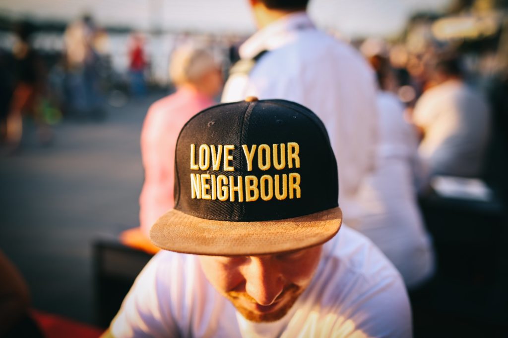 A baseball cap with Love Thy NEighbour written on it