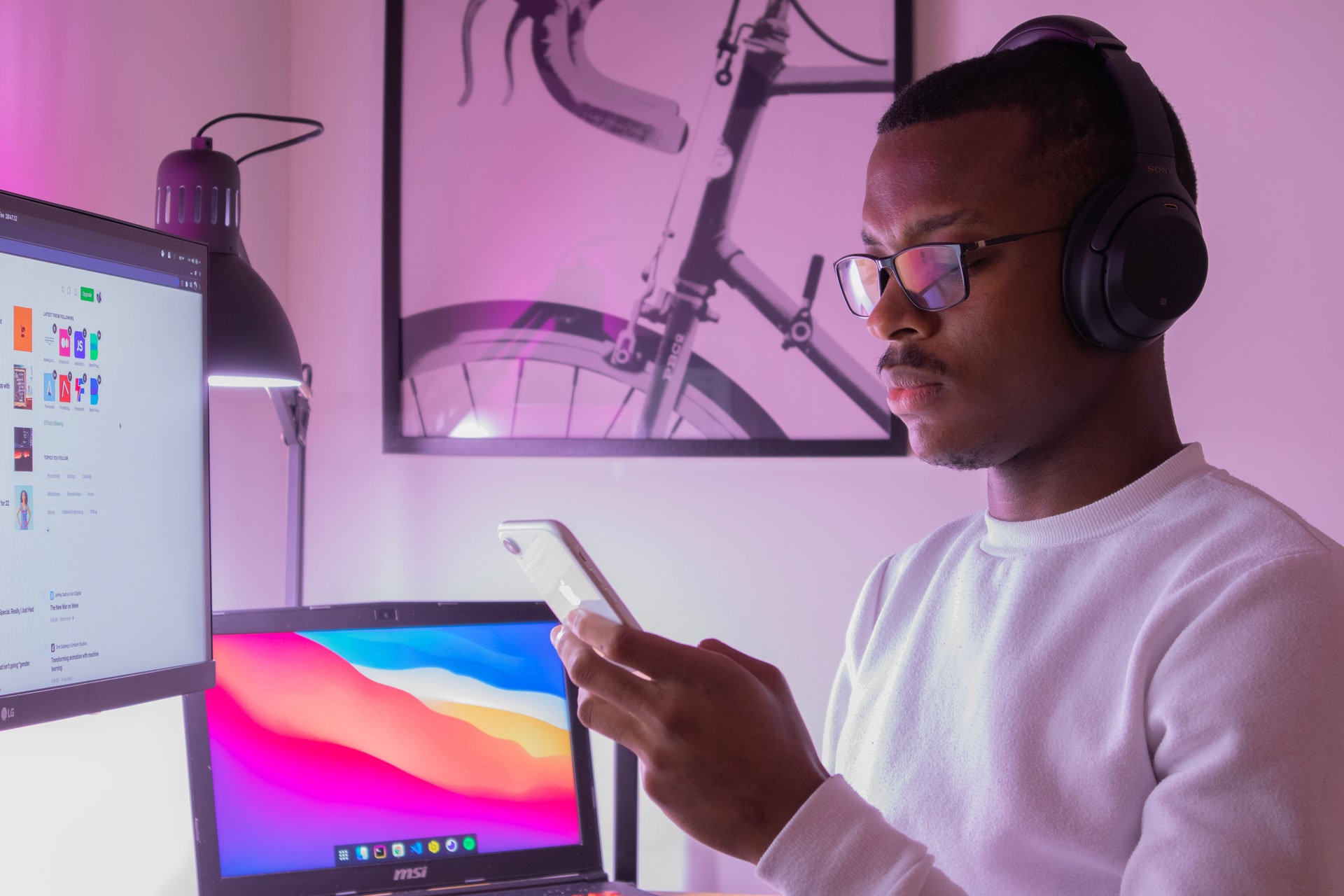 Man engaging with many screens at once