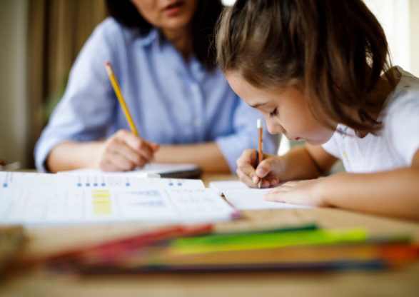 Women and child working together over school work